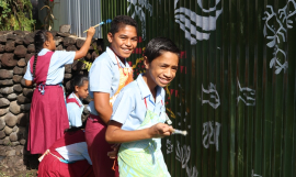 Students from Vaivase Primary School help paint the SPREP mural